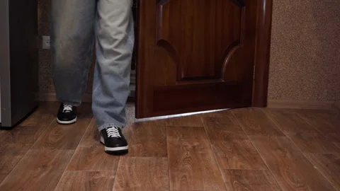 Leaving room guy in jeans and sneakers low angle Stock-Footage 336189385