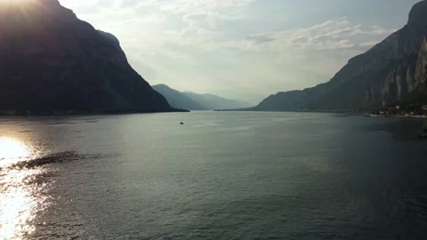 Lecco and Como lake at sunset with boat passing by: Mountains surround the lake Stock Footage 196615658