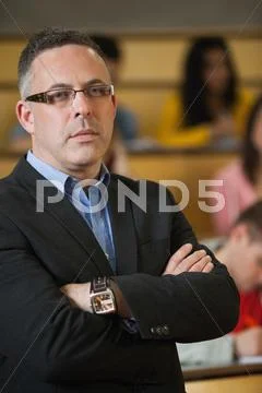 Lecturer frowning at camera in front of class Stock Photos
