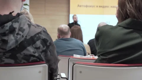 The lecturer gestures emotionally while leading the conference. Back view. Video stock 153549597