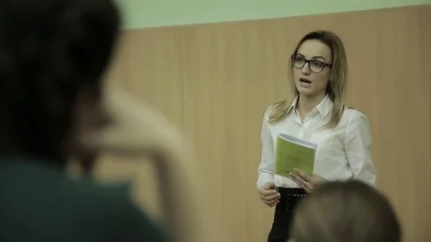 Lecturer speaking to his class in the lecture hall at the university Stock Footage 73365242