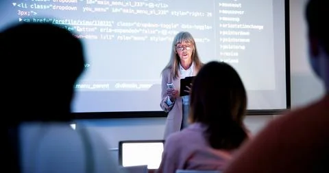 Lecturer, students and presentation with tablet in classroom, programming c.. Stock Photos