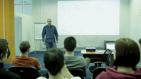 Lecturer is talking to a group in a small audience Video stock 55252623