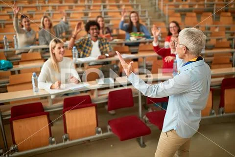 Lecturer in university - students listening to teacher in the classroom on co Stock Photos