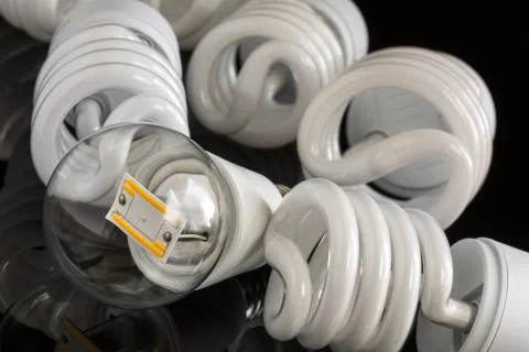Led bulb between several CFL lamps Фото