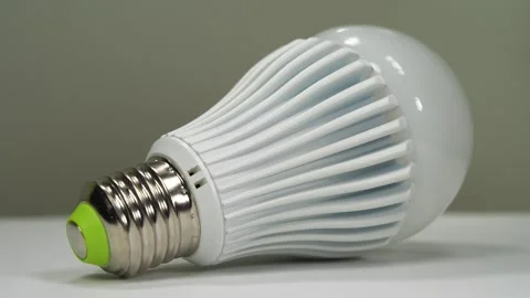 LED bulb with E27 base on a grey background Stock Footage 344697792