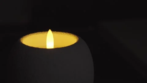 Led Candle On Black Background Round White Body And Pulsing Light Stock Footage 324848897