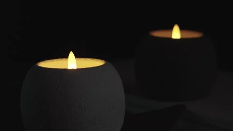Led Candles On Black Background Round White and Dark Body Pulsing Light Stock Footage 324886730