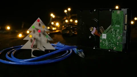LED christmas tree with hard drive in background and ethernet cable around it. Stock-Footage 81669088