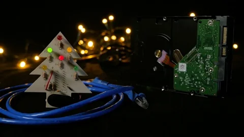 LED christmas tree with hard drive in background and ethernet cable around it. Video stock 81669355