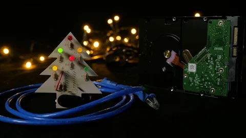 LED christmas tree with hard drive in background and ethernet cable around it. Video stock 81669529