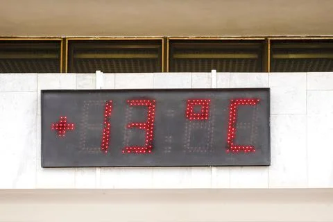 LED DISPLAY on a building facade. LED display shows the temperature. Temper.. Stock Photos