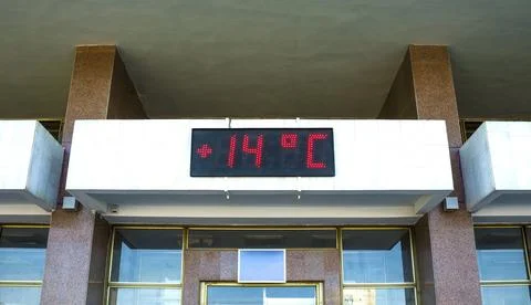 LED DISPLAY on a building facade. LED display shows the temperature. Temper.. Stock Photos