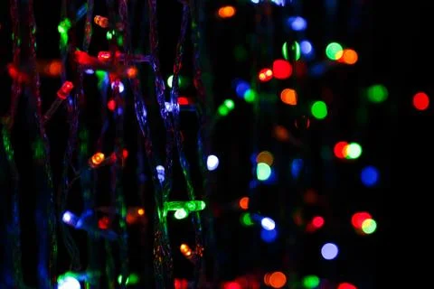 LED electric Christmas lights on dark background Stock Photos
