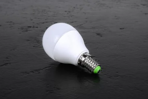 LED energy-saving light bulb on a black background. ECO energy concept Stock Photos