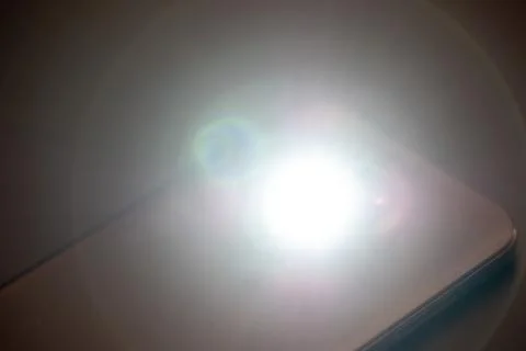 LED Flash or Flashlight of a Smartphone on black background Stock Photos