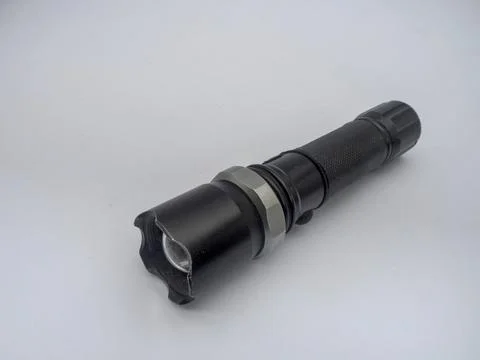 An LED flashlight is displayed against a plain white background. Stock Photos