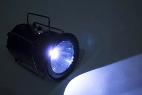 Led flashlight light in the dark background Stock Photos