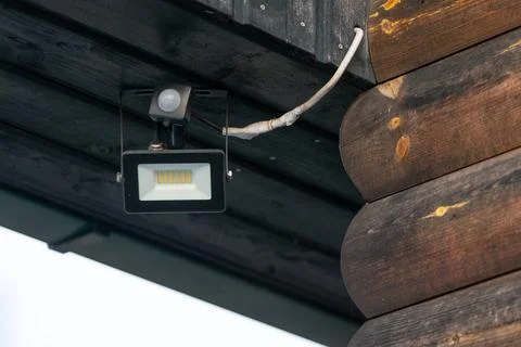 LED floodlight with sensor at home. How to install a floodlight properly. Stock Photos
