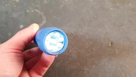 LED, handheld flashlight. Compact flashlight on battery. Flashlight light. Video stock 270431302