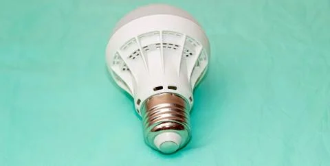 Led lamp close-up on a turquoise background. Stock Photos