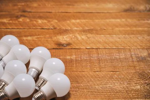 LED lamps with E27 socket are lying on the table Stock Photos