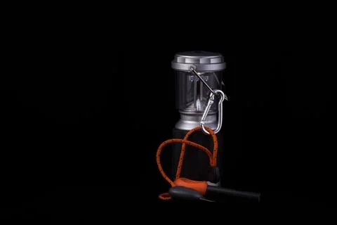 LED lantern and firestarter isolated on a black background. Stock Photos