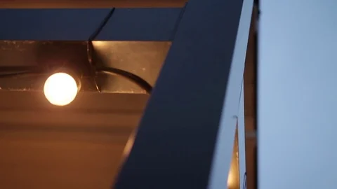 LED lantern bulb string lights with black wire attached to beam construction Video stock 72603212