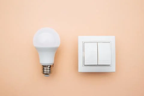 LED light bulb and switch on. Power energy economy concept Stock Photos
