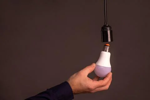 LED light bulb in hand. concept Stock Photos
