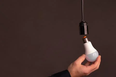 LED light bulb in hand. Stock Photos