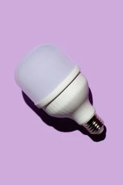 LED light bulb with hard shadows on a purple background Stock Photos