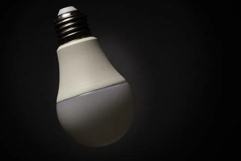 LED light bulb isolated on dark background close-up Stock Photos