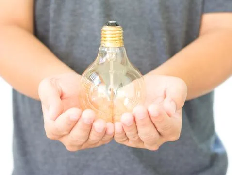 LED light bulb (lamp) in hand Isolated on white background Stock Photos