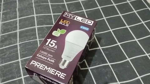 LED Light Bulb Packaging Box on Fabric Background – Energy Saving Lighting Produ Stock Footage 340413957