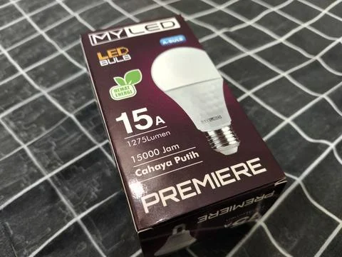 LED Light Bulb Packaging Box on Fabric Background – Energy Saving Lighting Produ Стоковые фото
