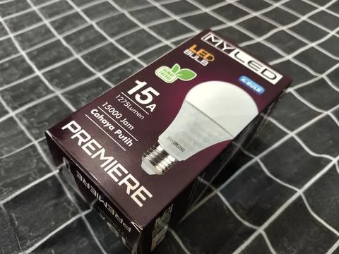 LED Light Bulb Packaging Box on Fabric Background – Energy Saving Lighting Produ Stock Photos