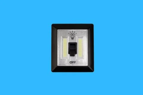 LED Light switch isolated on blue background Fotos Stock