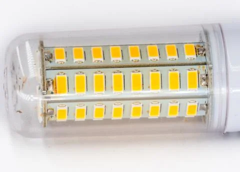 Led light yellow diodes inside plastic transparent cover closeup on white. Stock Photos