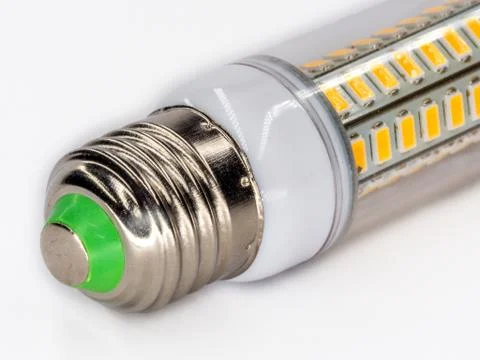 Led light with yellow diodes inside plastic transparent cover closeup on white. 库存照片