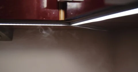  led lights in kitchen with steam from boiling water kettle Stock Footage 123386685