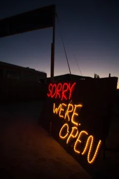 Led lights at night saying sorry we are open Stock Photos