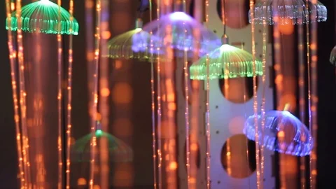 Led lights strings with hanging glowing jellyfishes, magical ornate garlands Video stock 126886379