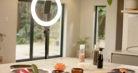 LED ring light is powering on, camera is panning down and revealing condiments, Stock Footage 340986885