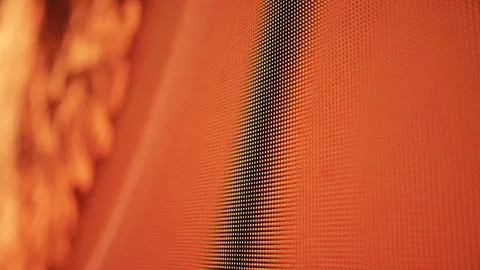 LED screen pixels creating modern digital display with abstract orange red light Stock Photos