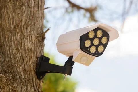 LED security light with motion sensor shaped like surveillance camera mount.. Stock Photos