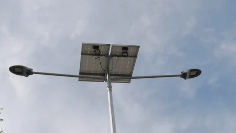LED street lamp getting electricity from the solar cell Stock Footage 106571804