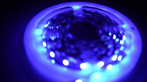 Led strip coil closeup. Diode shining stripe on dark blue background. Stock Footage 113009225