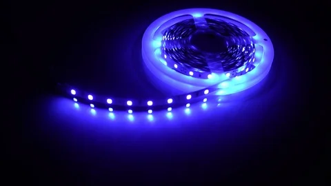 Led strip coil closeup. Diode shining stripe on dark blue background. Stock Footage 113009462
