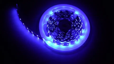 Led strip coil closeup. Diode shining stripe on dark blue background. Stock Footage 113009741